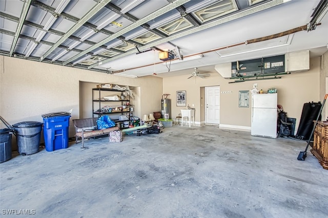 garage with gas water heater, ceiling fan, sink, white fridge, and a garage door opener