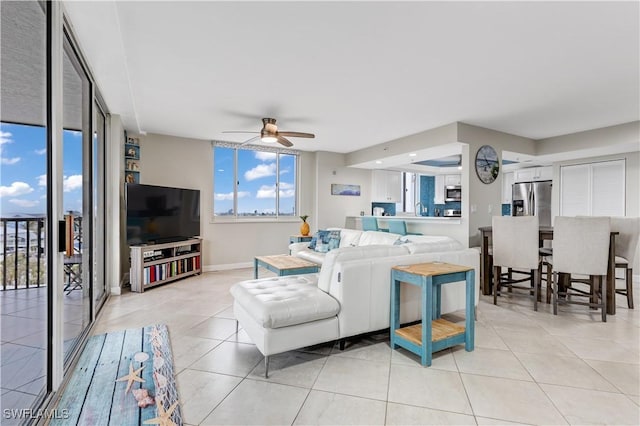 living room featuring ceiling fan and light tile patterned flooring