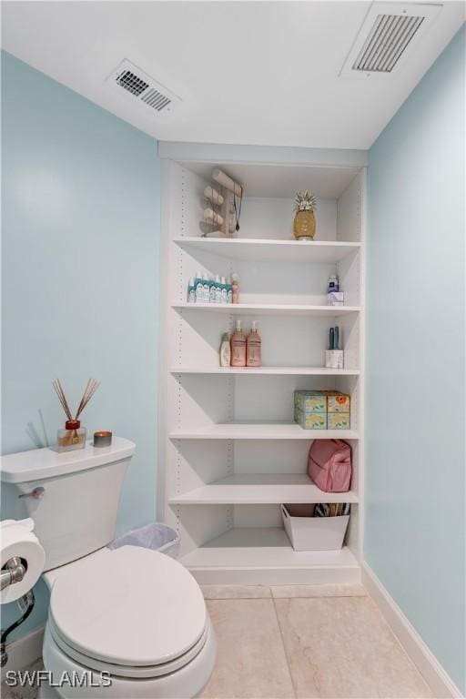 bathroom with tile patterned floors and toilet