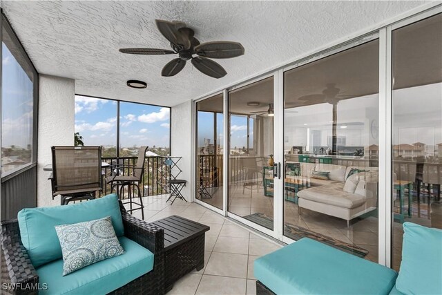 sunroom featuring ceiling fan