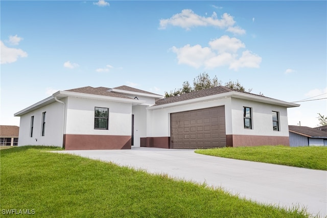 view of front of home with a garage and a front yard