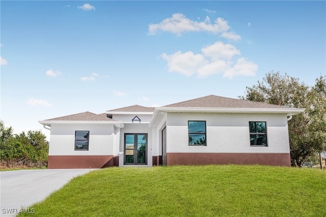 view of front of house featuring french doors and a front yard