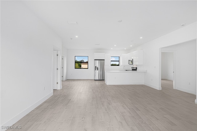 unfurnished living room with light hardwood / wood-style floors