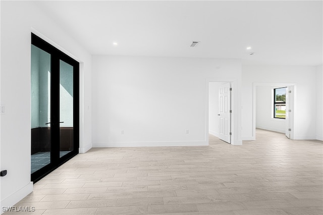 empty room with light hardwood / wood-style floors