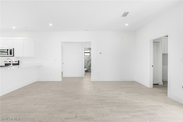 unfurnished living room with light hardwood / wood-style floors