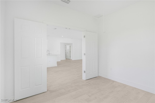 corridor with light hardwood / wood-style floors