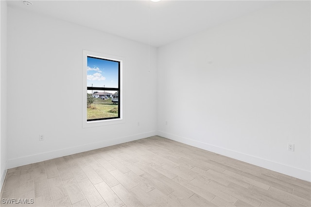 unfurnished room with light wood-type flooring