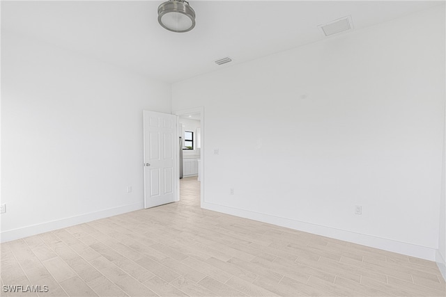 unfurnished room featuring light hardwood / wood-style flooring