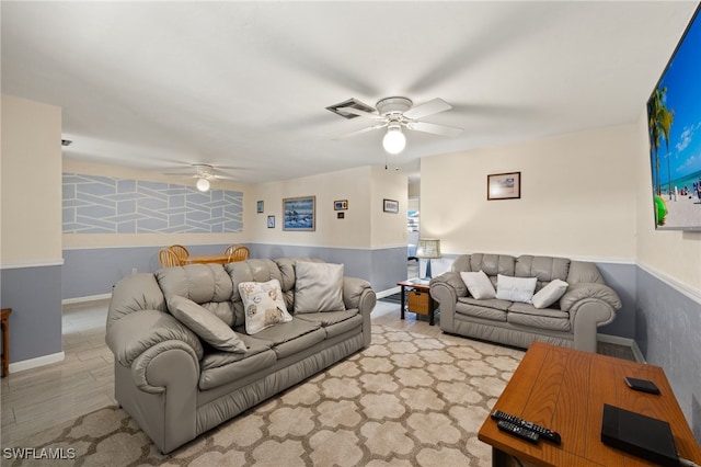 living room with light hardwood / wood-style flooring and ceiling fan