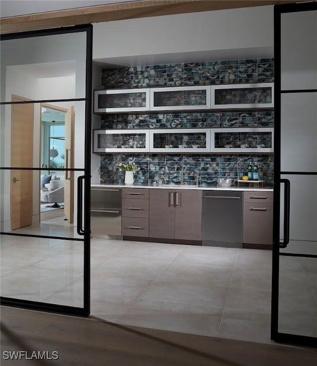 27804 Hickory Blvd, Bonita Springs, FL 34134 - indoor wet bar with dishwasher, decorative backsplash, and light tile patterned floors