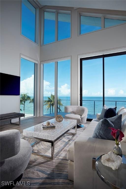 27804 Hickory Blvd, Bonita Springs, FL 34134 - living room with a water view, a towering ceiling, and wood finished floors