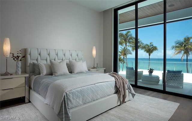 27804 Hickory Blvd, Bonita Springs, FL 34134 - bedroom with floor to ceiling windows, multiple windows, access to outside, light wood-style flooring, and a water view