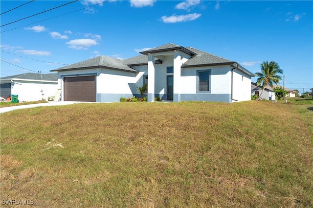 view of front of property with a front yard and a garage