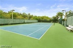 view of tennis court featuring basketball hoop