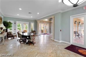 dining area with a notable chandelier and crown molding