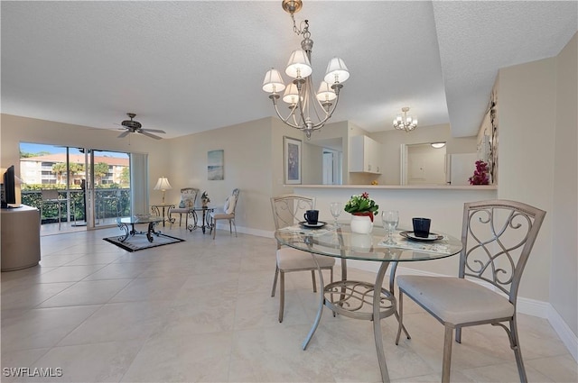 dining space featuring a textured ceiling, ceiling fan with notable chandelier, and light tile patterned flooring