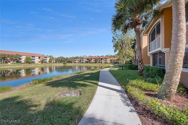 view of property's community featuring a yard and a water view