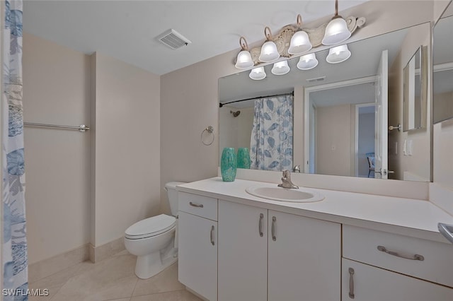 bathroom with toilet, vanity, tile patterned floors, and walk in shower