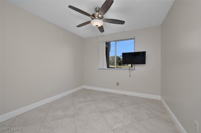 unfurnished room featuring ceiling fan and a textured ceiling