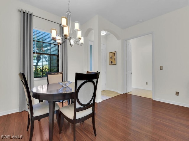 dining room featuring hardwood / wood-style floors and a notable chandelier