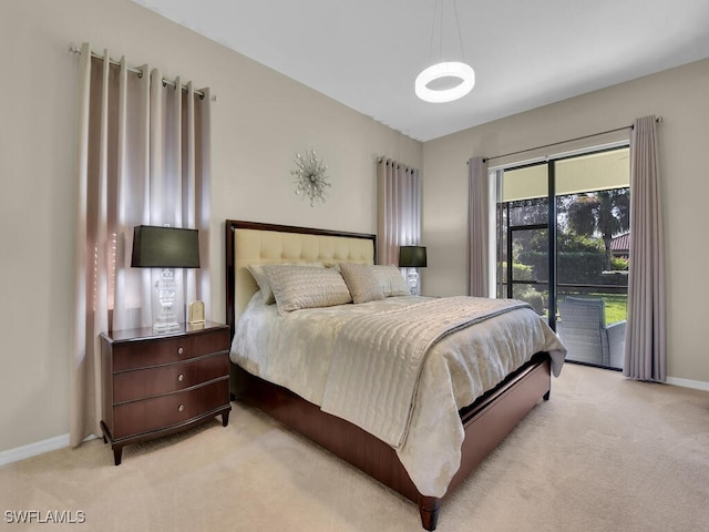 bedroom with access to outside and light colored carpet