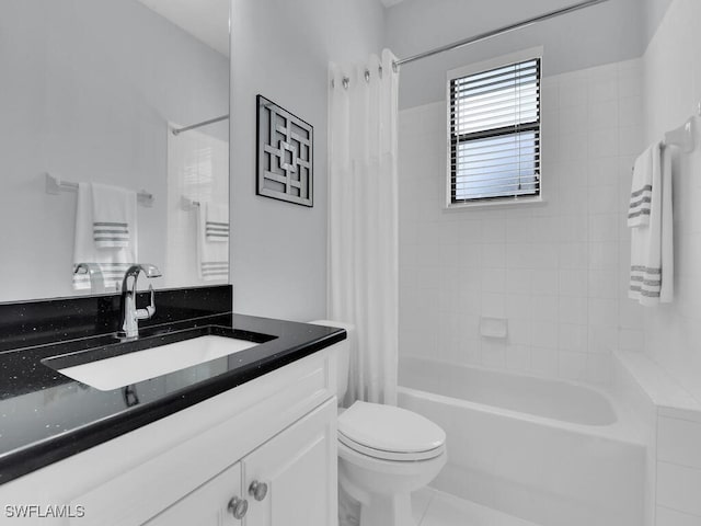 full bathroom featuring tile patterned floors, shower / tub combo with curtain, vanity, and toilet