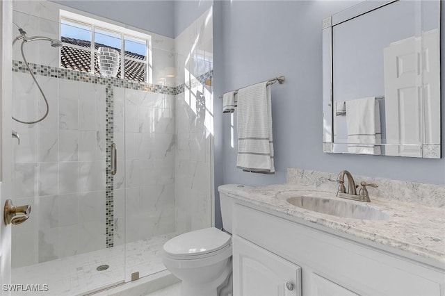 bathroom with vanity, toilet, and walk in shower