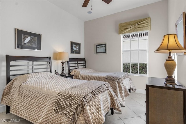 tiled bedroom featuring ceiling fan