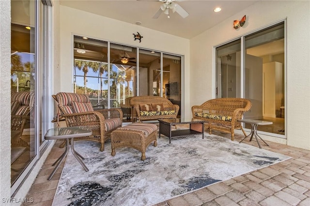 view of patio with an outdoor living space and ceiling fan