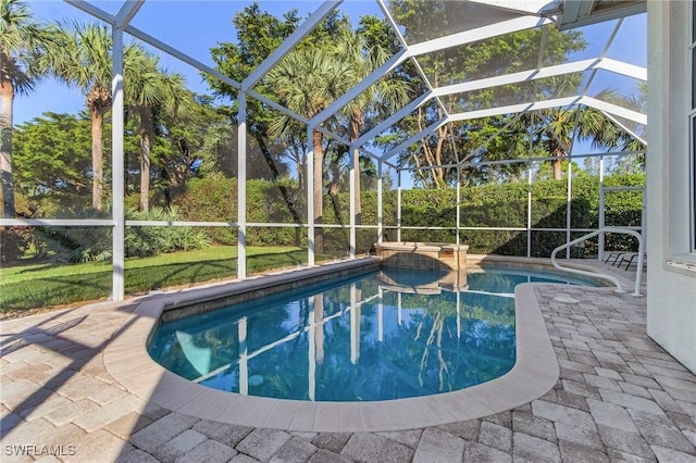 view of swimming pool featuring a patio and a lanai