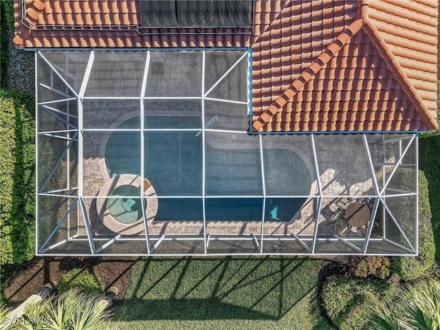 view of side of home featuring glass enclosure