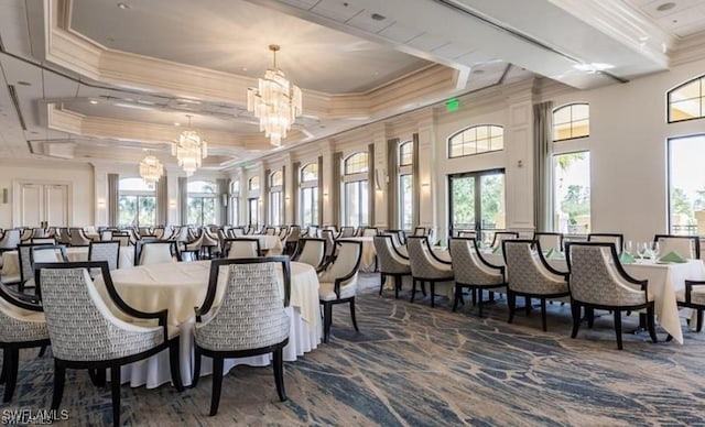 dining room featuring ornamental molding, a wealth of natural light, and a notable chandelier