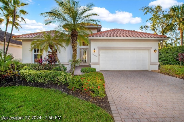 20000 Seadale Ct, Estero, FL 33928 - mediterranean / spanish-style house with a garage