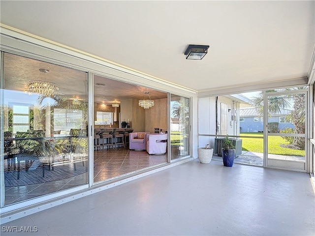 unfurnished sunroom featuring a notable chandelier