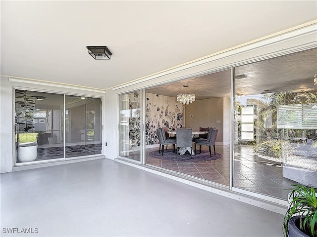 unfurnished sunroom featuring a notable chandelier