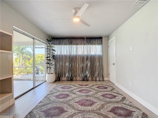 unfurnished room with ceiling fan and light wood-type flooring