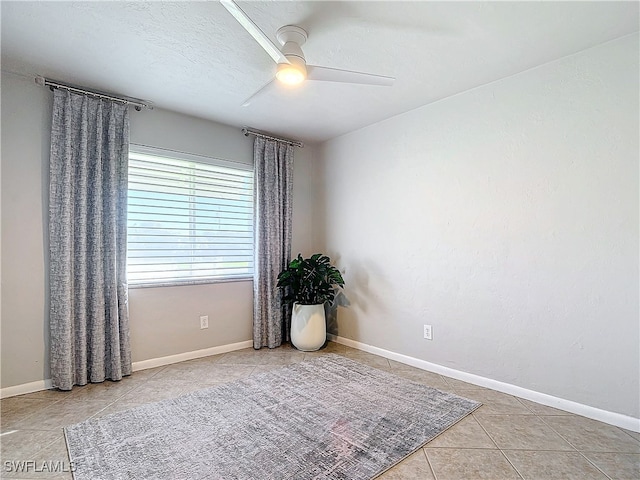 tiled empty room with ceiling fan