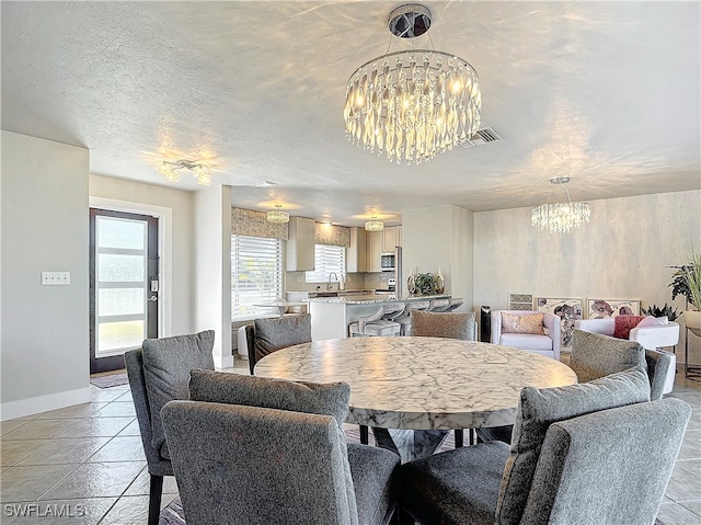 dining area with a chandelier and a textured ceiling