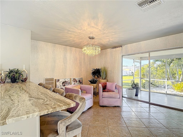 tiled dining area with a notable chandelier