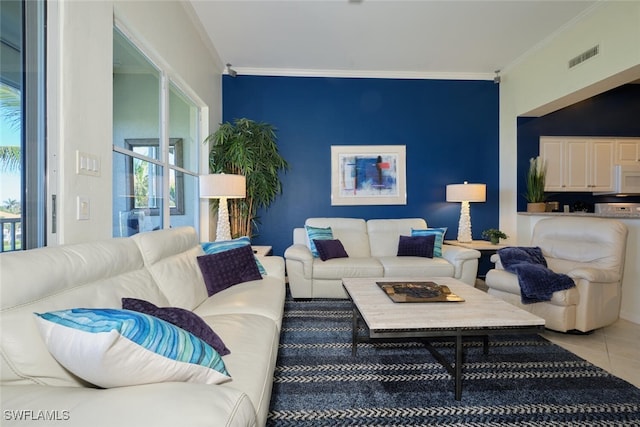 living room with tile patterned floors and ornamental molding