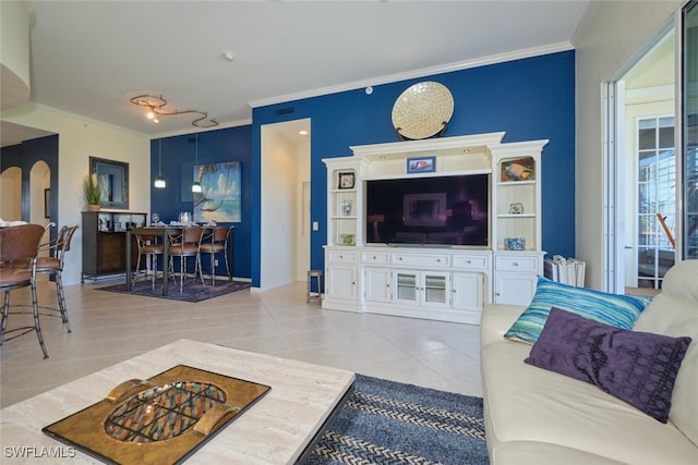 living room with light tile patterned floors and ornamental molding