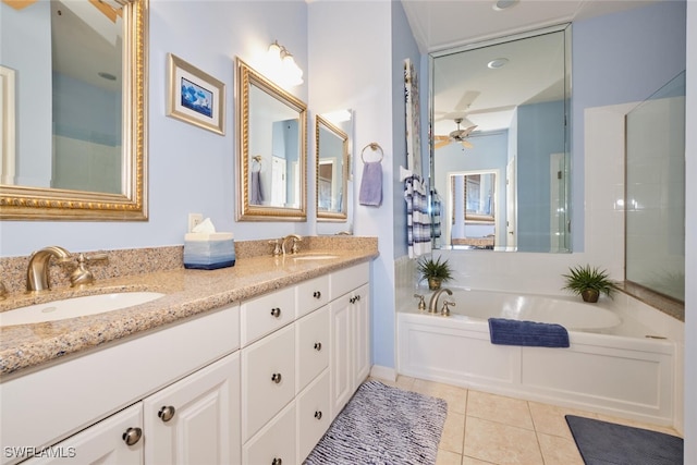 bathroom featuring tile patterned floors, ceiling fan, vanity, and a bath