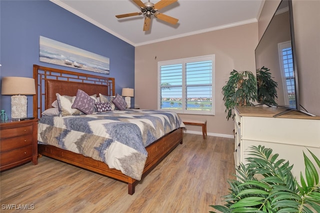 bedroom featuring ceiling fan, light wood-type flooring, and crown molding