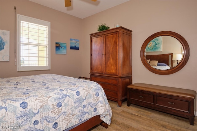 bedroom with light hardwood / wood-style flooring and ceiling fan