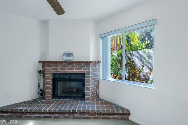 interior details with carpet flooring, ceiling fan, and a fireplace