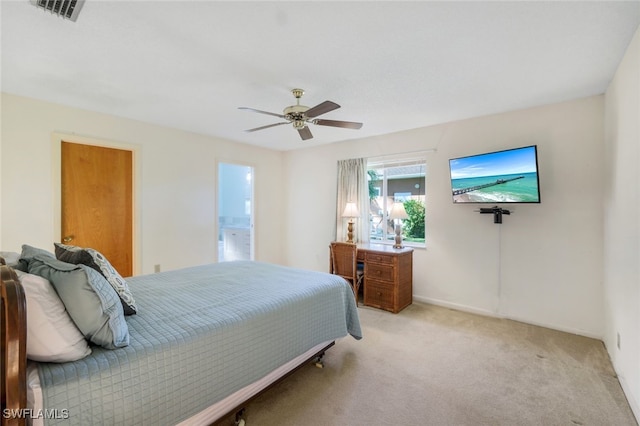 carpeted bedroom with ceiling fan and ensuite bathroom