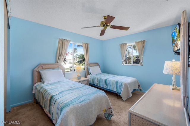 bedroom with carpet flooring, a textured ceiling, and ceiling fan