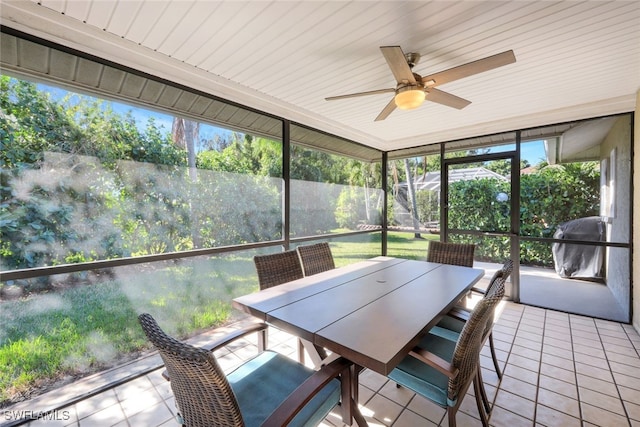 unfurnished sunroom with ceiling fan