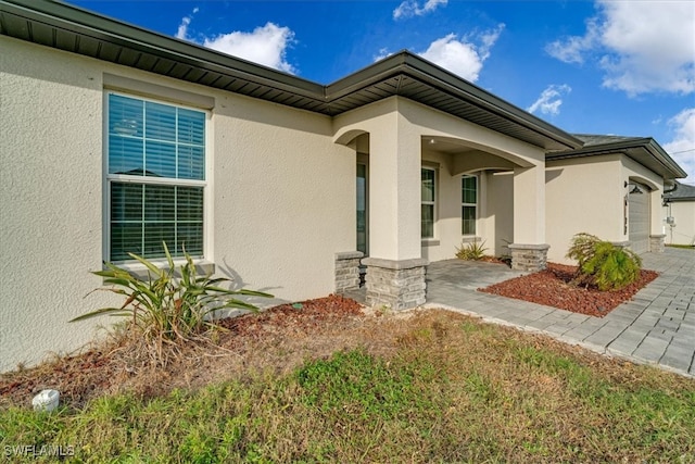 view of exterior entry featuring a garage