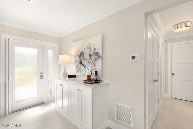 interior space with light tile patterned floors and crown molding